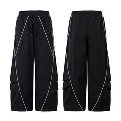 Black wide-leg track pants with white reflective curved line detailing, shown front and back view on white background