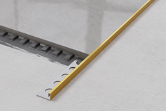 Rectified JS decorative corner profile in satin gold stainless steel