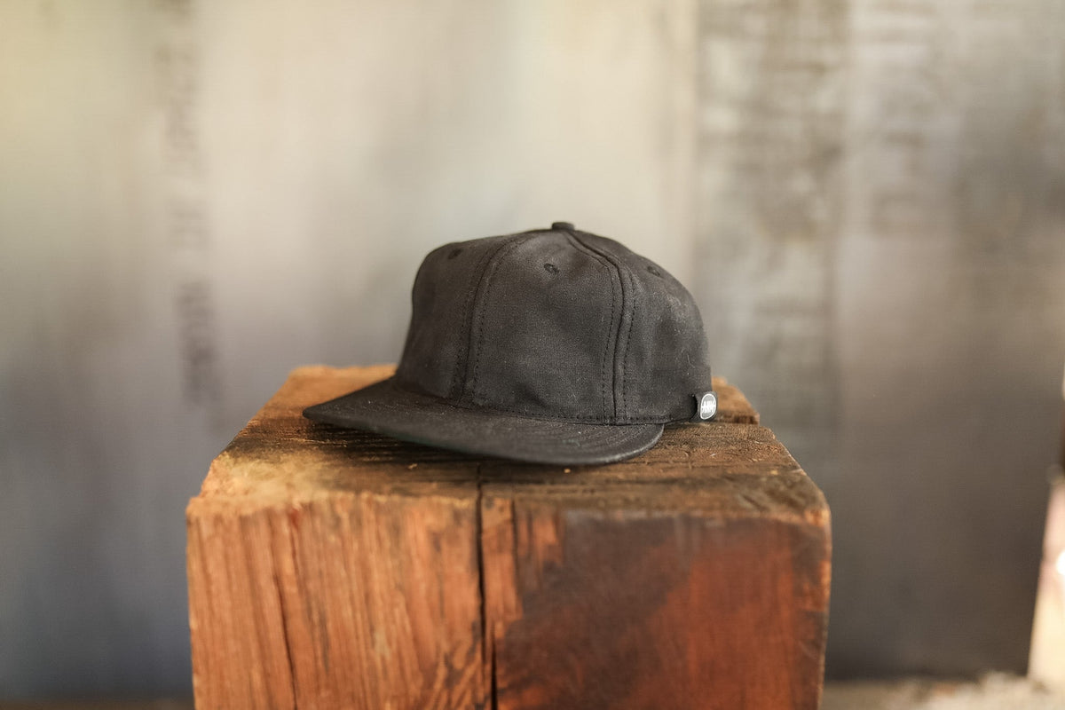 Black cap on a wooden block with a blurred background